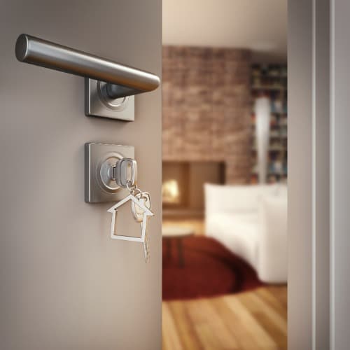 key in lock of open door to home